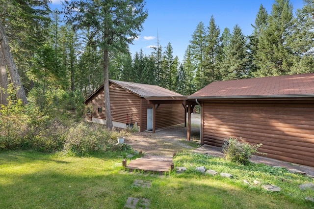 176 Blaine Ridge Rd, Kalispell, MT 59901 - view of side of property with a yard, log veneer siding, and an outbuilding