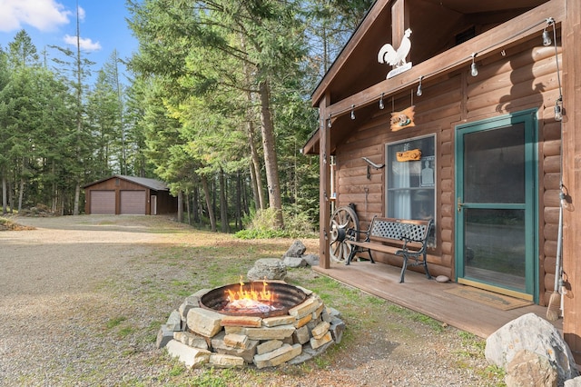 176 Blaine Ridge Rd, Kalispell, MT 59901 - view of yard featuring an outdoor fire pit, a garage, and an outdoor structure