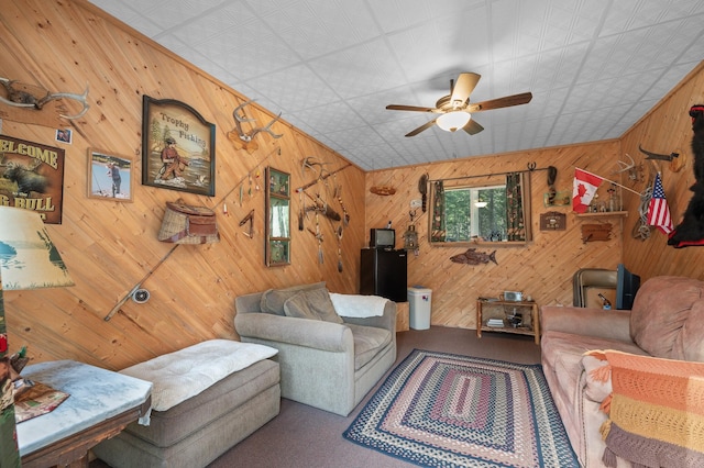 176 Blaine Ridge Rd, Kalispell, MT 59901 - living room with carpet, a ceiling fan, and wood walls