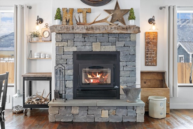 537 Rainbow Ridge Trl, Columbia Falls, MT 59912 - detailed view of wood finished floors, a stone fireplace, and baseboards