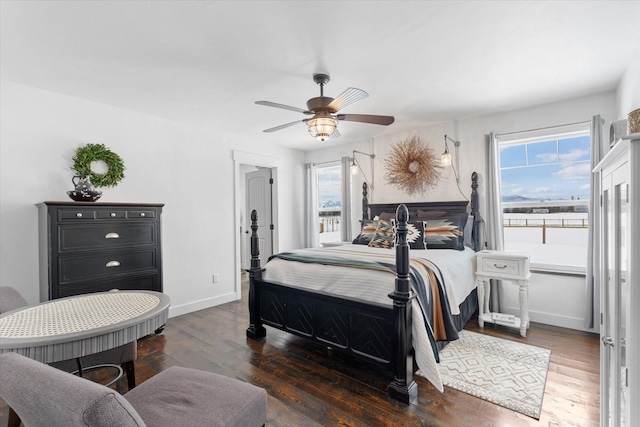 537 Rainbow Ridge Trl, Columbia Falls, MT 59912 - bedroom with wood finished floors, baseboards, and a ceiling fan
