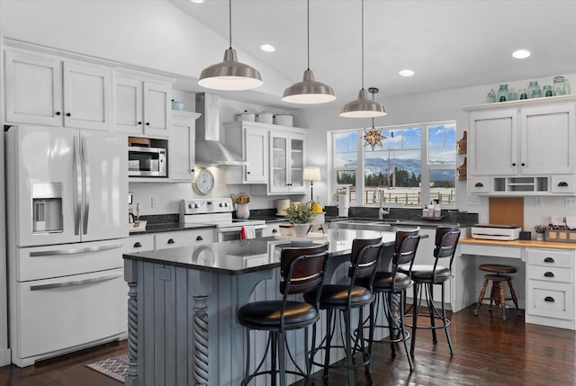537 Rainbow Ridge Trl, Columbia Falls, MT 59912 - kitchen with fridge with ice dispenser, wall chimney exhaust hood, white electric stove, stainless steel microwave, and dark wood-type flooring
