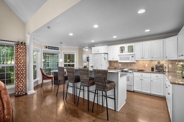 3 Bearberry Ln, Whitefish, MT 59937 - kitchen featuring white appliances, a breakfast bar, white cabinetry, crown molding, and recessed lighting