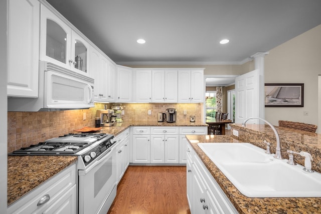 3 Bearberry Ln, Whitefish, MT 59937 - kitchen with white appliances, glass insert cabinets, light wood-style flooring, white cabinetry, and backsplash