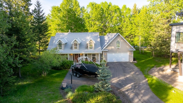 3 Bearberry Ln, Whitefish, MT 59937 - cape cod house with asphalt driveway, a front yard, and an attached garage