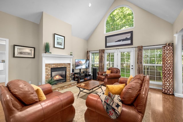 3 Bearberry Ln, Whitefish, MT 59937 - living room featuring high vaulted ceiling, wood finished floors, a fireplace, and plenty of natural light