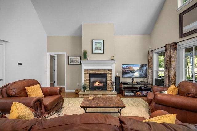 3 Bearberry Ln, Whitefish, MT 59937 - living area with high vaulted ceiling, wood finished floors, and a fireplace