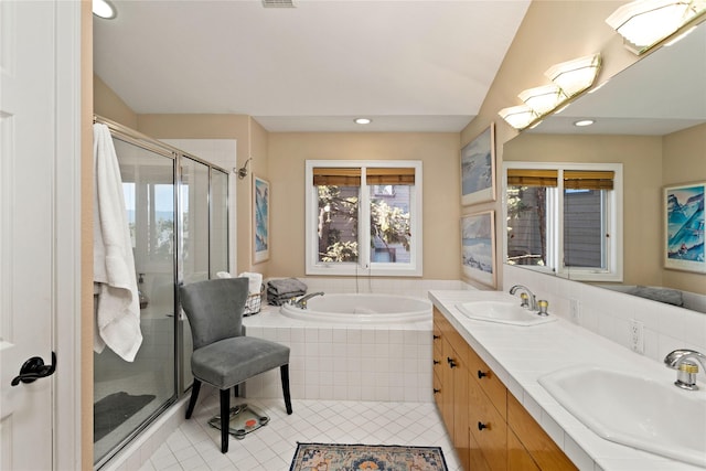 267 Eagle Bend Dr, Bigfork, MT 59911 - bathroom with tile patterned floors, a bath, double vanity, a stall shower, and recessed lighting