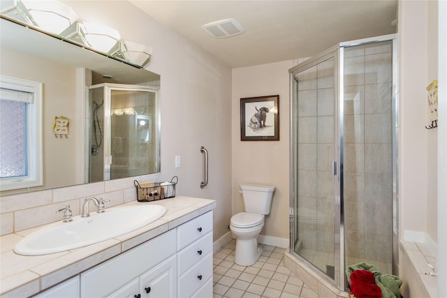 267 Eagle Bend Dr, Bigfork, MT 59911 - full bath featuring vanity, toilet, a shower stall, and tile patterned flooring