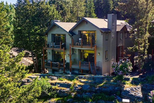 267 Eagle Bend Dr, Bigfork, MT 59911 - view of front facade with a balcony and a chimney