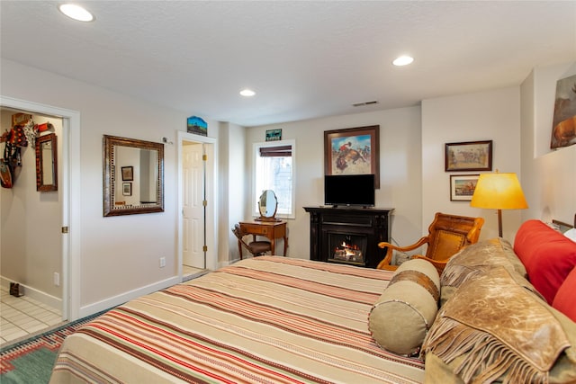 267 Eagle Bend Dr, Bigfork, MT 59911 - tiled bedroom featuring recessed lighting, baseboards, and a lit fireplace