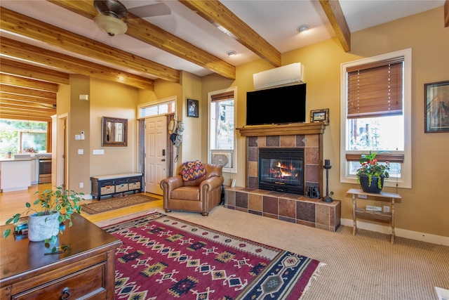 267 Eagle Bend Dr, Bigfork, MT 59911 - carpeted living area with a tile fireplace, a ceiling fan, baseboards, and beamed ceiling