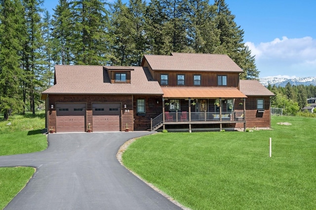 33 Shale Ct, Kalispell, MT 59901 - view of front of property with a front yard, an attached garage, asphalt driveway, and covered porch