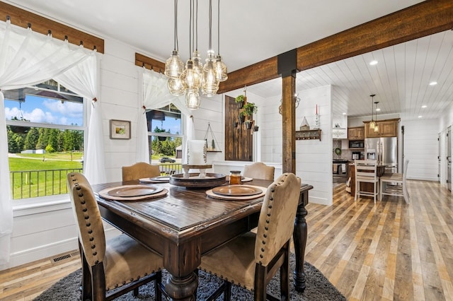 33 Shale Ct, Kalispell, MT 59901 - dining space featuring light wood-type flooring, a chandelier, healthy amount of natural light, recessed lighting, and wooden walls