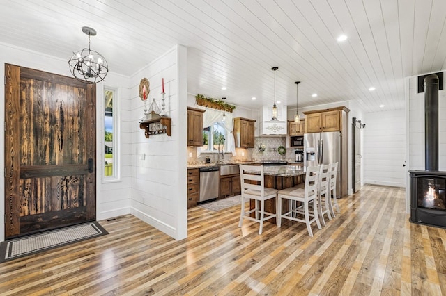33 Shale Ct, Kalispell, MT 59901 - entrance foyer with a wood stove, light wood finished floors, healthy amount of natural light, recessed lighting, and wood ceiling