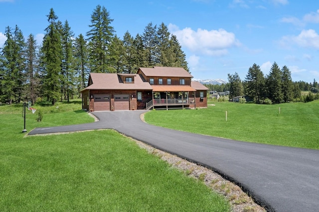 33 Shale Ct, Kalispell, MT 59901 - view of front of house with driveway, a front lawn, a garage, and a porch