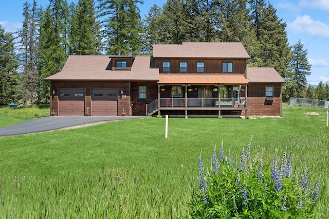 33 Shale Ct, Kalispell, MT 59901 - view of front facade with a garage, a front yard, asphalt driveway, and covered porch