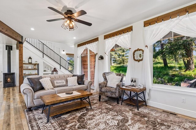 33 Shale Ct, Kalispell, MT 59901 - living area featuring wood finished floors, ceiling fan, stairs, a wood stove, and recessed lighting