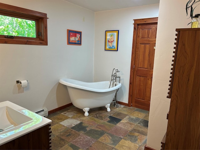 9200 River Rd, Bozeman, MT 59718 - full bath with a freestanding tub, stone finish flooring, a baseboard radiator, and vanity