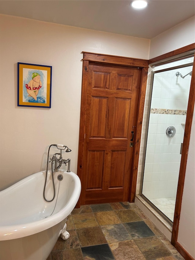 9200 River Rd, Bozeman, MT 59718 - full bathroom with stone tile floors, a shower stall, and a soaking tub