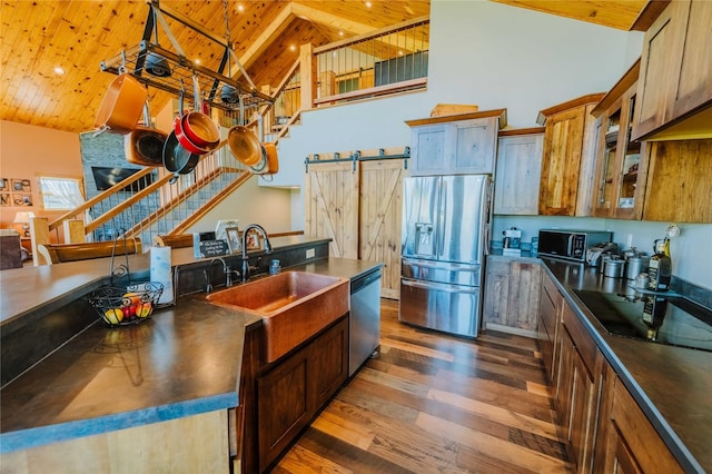 7 Papson Ridge Ln, Hall, MT 59837 - kitchen featuring black appliances, wooden ceiling, dark countertops, dark wood-style floors, and high vaulted ceiling