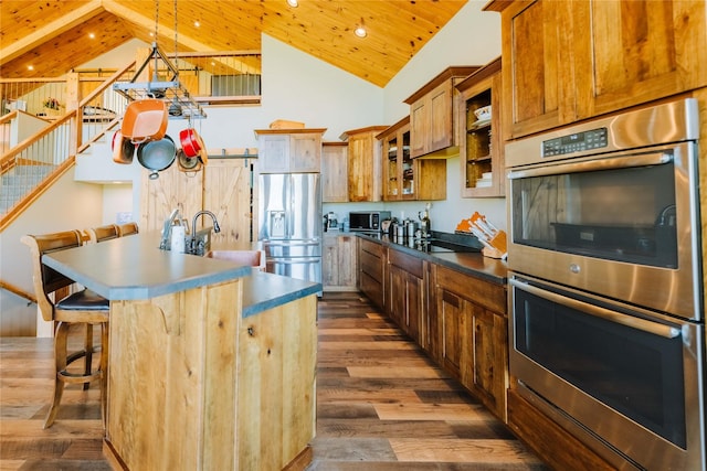 7 Papson Ridge Ln, Hall, MT 59837 - kitchen featuring black appliances, high vaulted ceiling, wood ceiling, dark wood-style flooring, and a center island with sink
