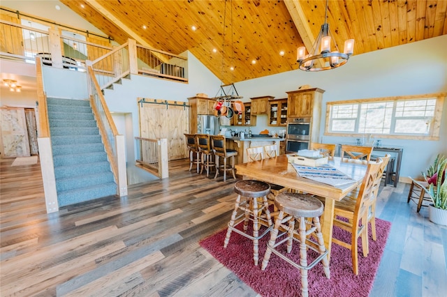 7 Papson Ridge Ln, Hall, MT 59837 - dining room featuring high vaulted ceiling, a chandelier, stairs, a wooden ceiling with exposed beams, and recessed lighting