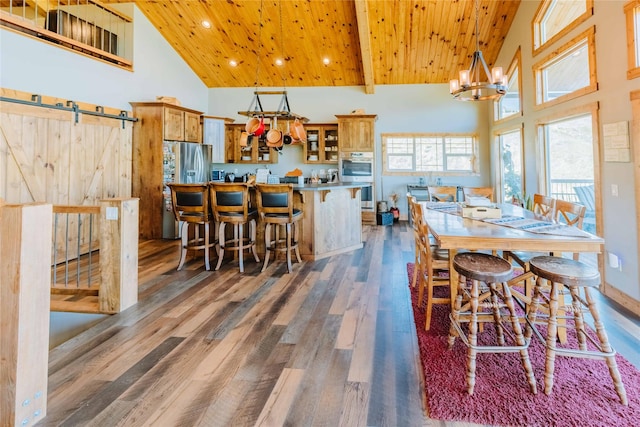7 Papson Ridge Ln, Hall, MT 59837 - dining space with high vaulted ceiling, wooden ceiling, dark wood-type flooring, a barn door, and a chandelier