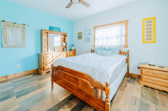 7 Papson Ridge Ln, Hall, MT 59837 - bedroom featuring multiple windows, light wood-type flooring, and a ceiling fan