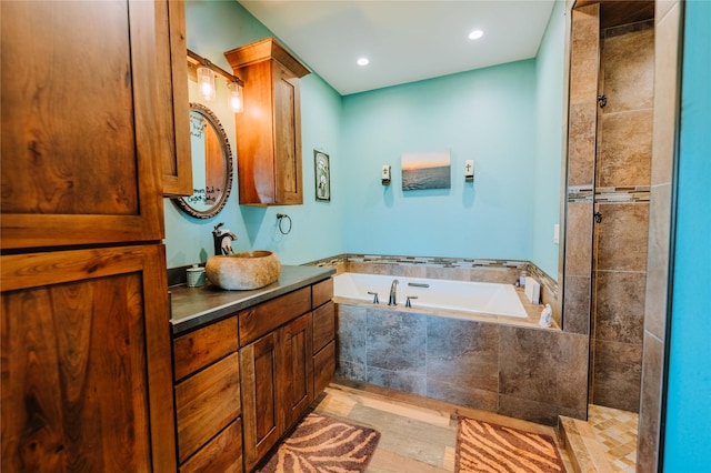 7 Papson Ridge Ln, Hall, MT 59837 - bathroom featuring a bath, vanity, a tile shower, wood finished floors, and recessed lighting