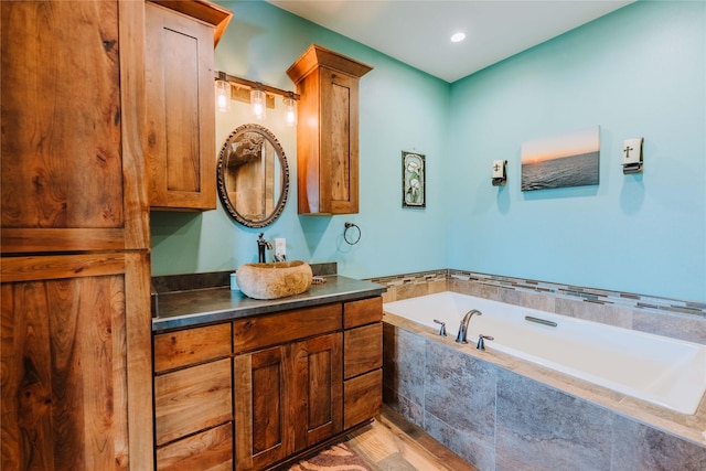 7 Papson Ridge Ln, Hall, MT 59837 - bathroom featuring vanity, a garden tub, and wood finished floors