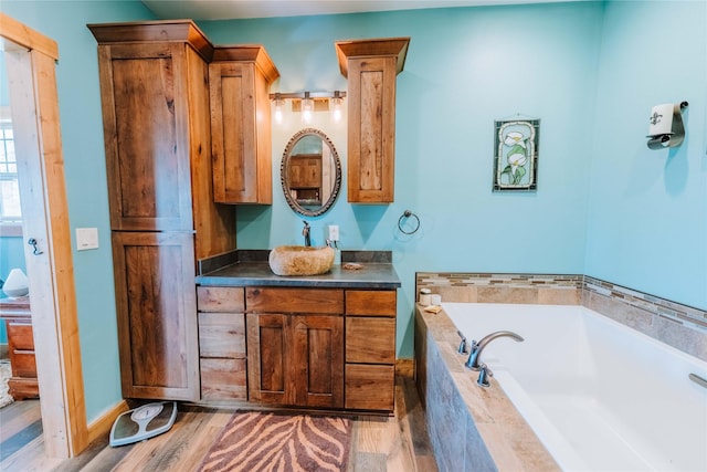 7 Papson Ridge Ln, Hall, MT 59837 - full bathroom with vanity, a bath, and wood finished floors