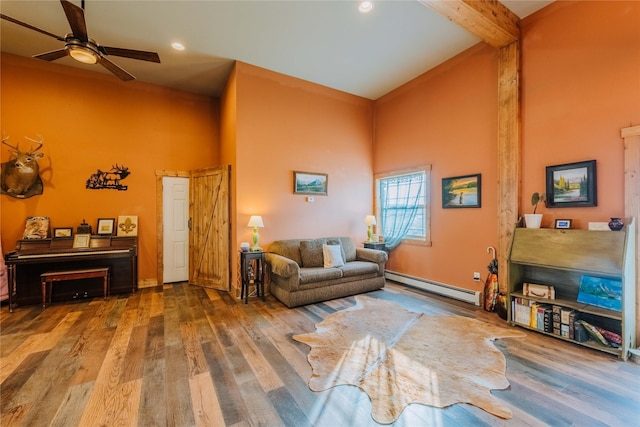 7 Papson Ridge Ln, Hall, MT 59837 - living area featuring a baseboard heating unit, a towering ceiling, wood finished floors, ceiling fan, and beam ceiling