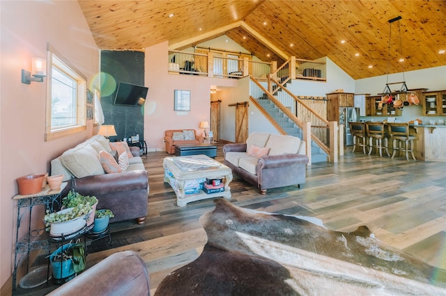 7 Papson Ridge Ln, Hall, MT 59837 - living area with stairway, wood finished floors, wooden ceiling, high vaulted ceiling, and recessed lighting