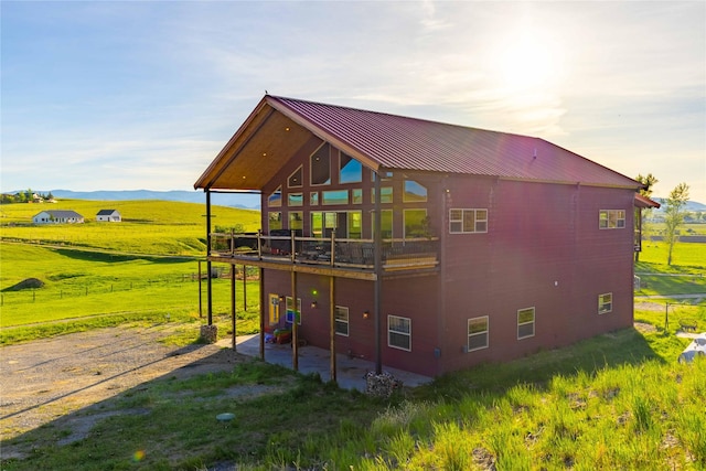 7 Papson Ridge Ln, Hall, MT 59837 - rear view of house with a patio, a lawn, a metal roof, and a deck with mountain view