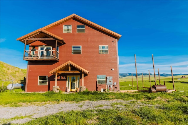 7 Papson Ridge Ln, Hall, MT 59837 - view of front of home featuring a balcony, a mountain view, and oil tank