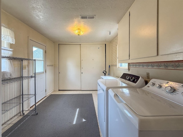 802 2nd St SW, Choteau, MT 59422 - washroom featuring cabinet space, independent washer and dryer, and a textured ceiling