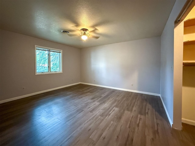 802 2nd St SW, Choteau, MT 59422 - spare room with ceiling fan, baseboards, dark wood-style floors, and a textured ceiling