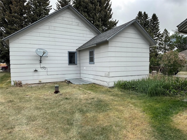 802 2nd St SW, Choteau, MT 59422 - back of property featuring a lawn and a shingled roof