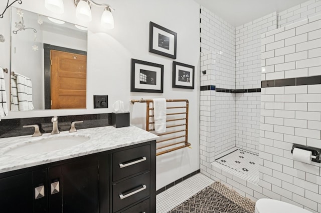 314 9th Ave W, Kalispell, MT 59901 - bathroom featuring vanity, tiled shower, tile patterned floors, and toilet