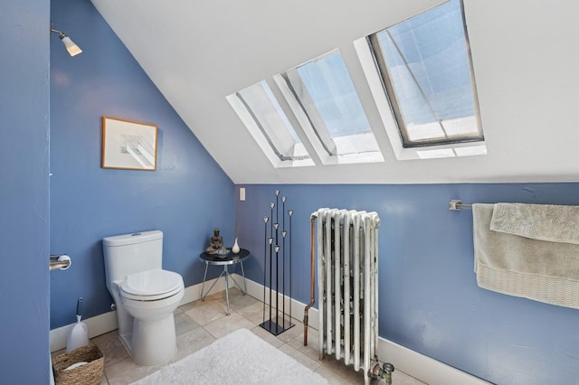 314 9th Ave W, Kalispell, MT 59901 - bathroom featuring radiator heating unit, a skylight, lofted ceiling, toilet, and baseboards