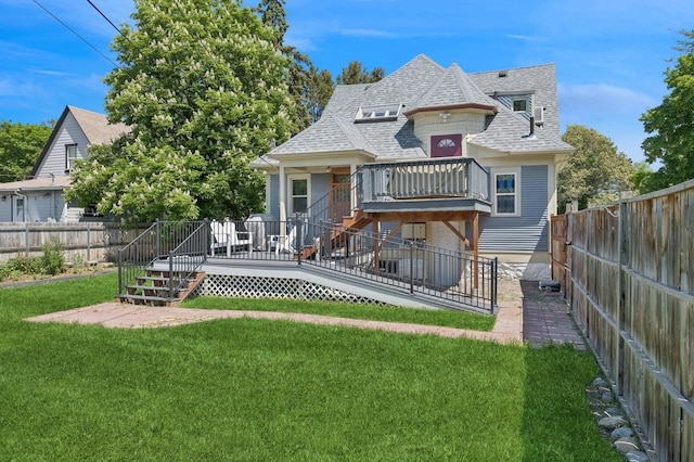 314 9th Ave W, Kalispell, MT 59901 - back of property featuring a fenced backyard, stairs, roof with shingles, and a deck