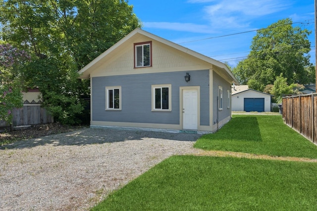 314 9th Ave W, Kalispell, MT 59901 - back of house featuring a garage, an outdoor structure, and driveway