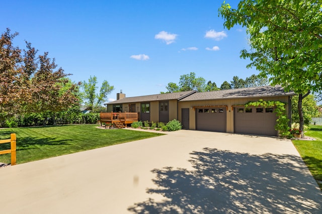 5489 Sahara Ct, Helena, MT 59602 - ranch-style house with an attached garage, a front lawn, concrete driveway, and a deck