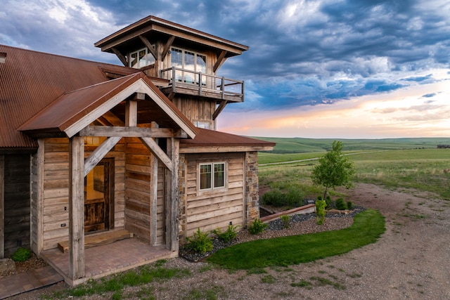 99 Little Belt Way, Belt, MT 59412 - back of house at dusk featuring a balcony