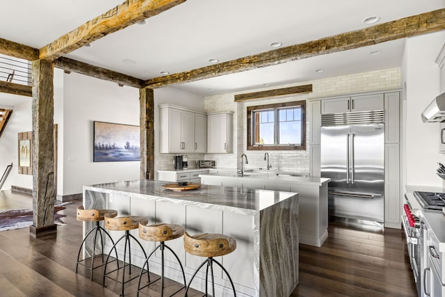 99 Little Belt Way, Belt, MT 59412 - kitchen with stainless steel built in fridge, a center island, beamed ceiling, dark wood-style floors, and decorative backsplash