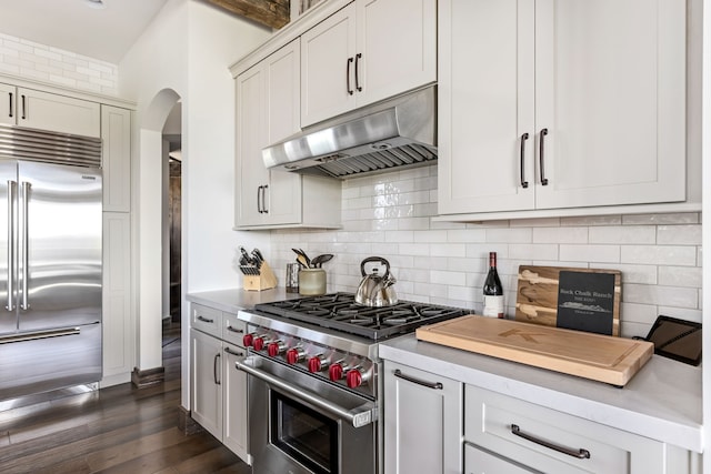 99 Little Belt Way, Belt, MT 59412 - kitchen with premium appliances, under cabinet range hood, arched walkways, and light countertops