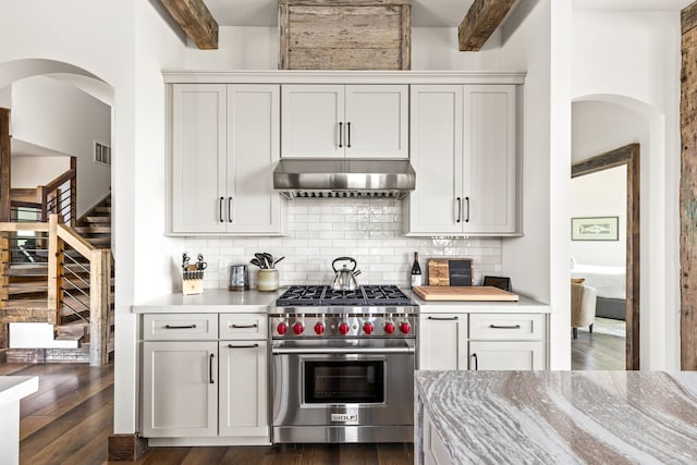 99 Little Belt Way, Belt, MT 59412 - kitchen with luxury range, under cabinet range hood, arched walkways, dark wood finished floors, and beam ceiling