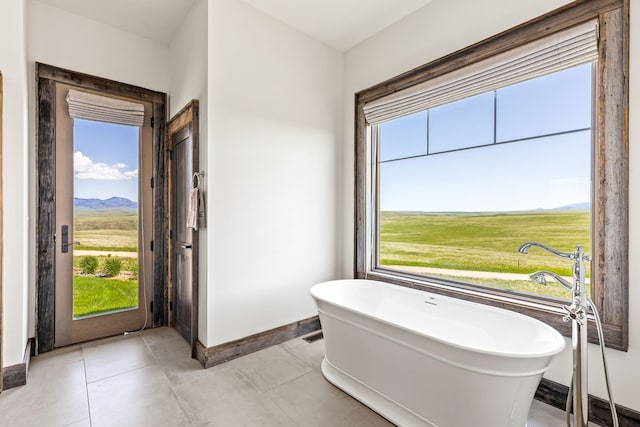 99 Little Belt Way, Belt, MT 59412 - bathroom with a freestanding tub, baseboards, and a mountain view