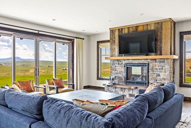 99 Little Belt Way, Belt, MT 59412 - living room featuring baseboards, a stone fireplace, wood finished floors, recessed lighting, and a mountain view